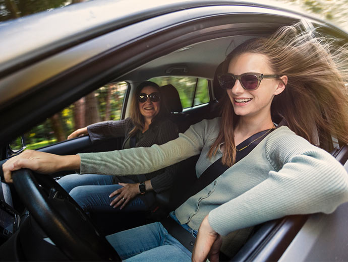 Teen driving their new car.