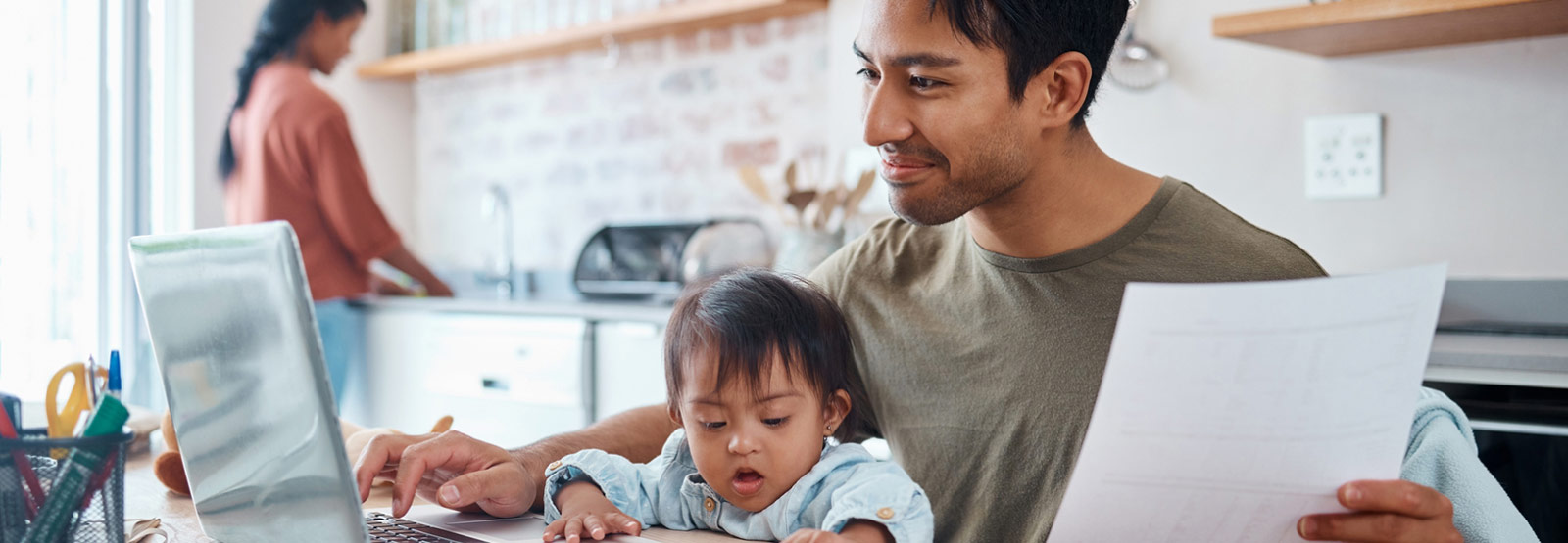 Parent and child sitting in front of a laptop.